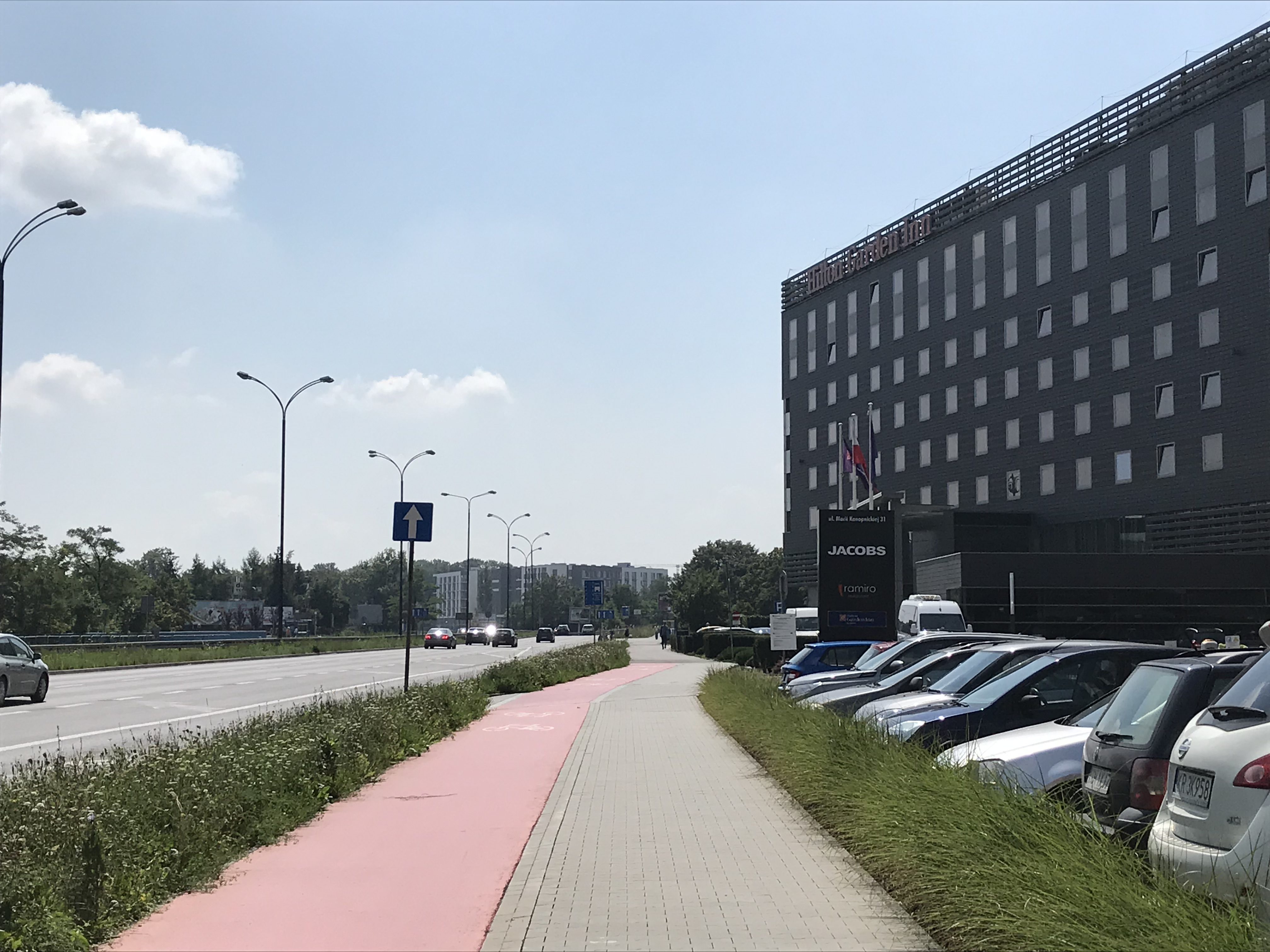 a sidewalk with cars parked on it