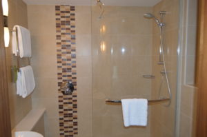 a bathroom with a shower and a white towel