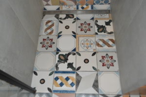 a floor with colorful tiles