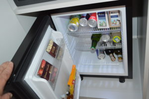 a mini fridge with drinks and beverages inside