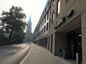 a street with a building and a church