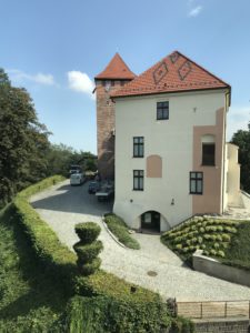 a white and brown building with a red roof