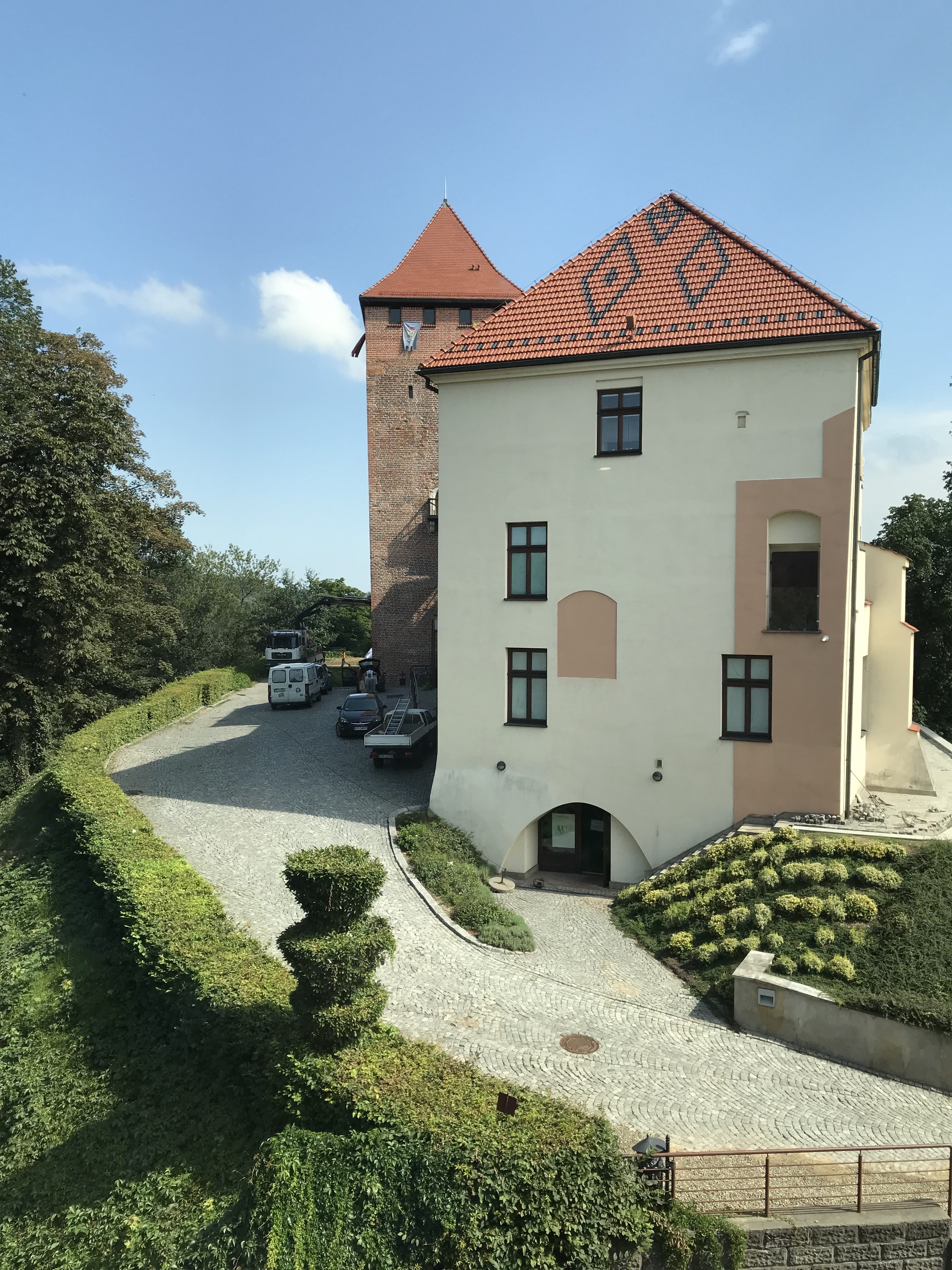 a building with a tower and a driveway