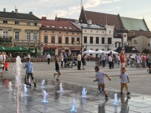 a group of kids playing in a fountain