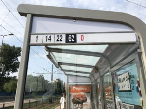 a bus stop with a sign