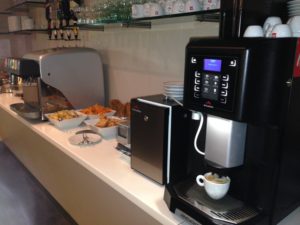 a coffee machine and food on a counter