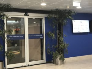 a glass doors with a plant in front of it