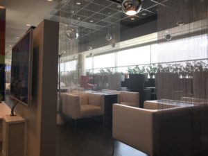 a room with white chairs and a window