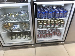 a refrigerator with cans of beer and other beverages