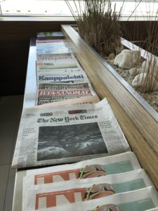 a row of newspapers on a shelf