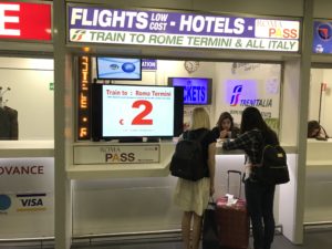 a group of women standing in front of a sign