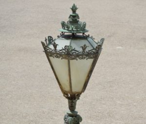 a lamp post with a glass shade