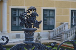a metal railing with a flower in it