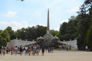 a group of people standing around a monument