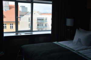 a bed with a window and a lamp