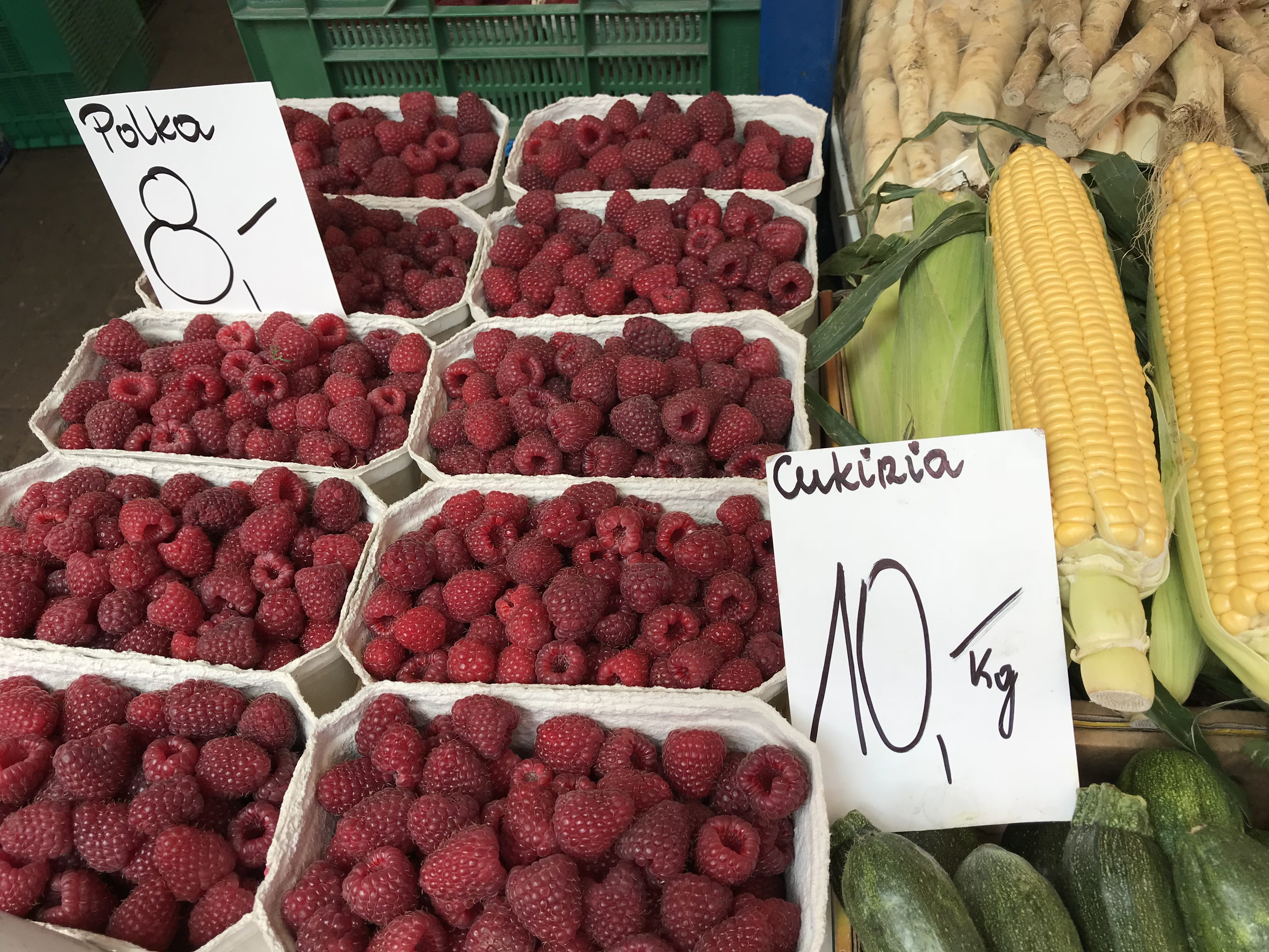 baskets of raspberries and corn on the cob