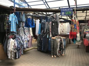 a market with clothes on the swingers