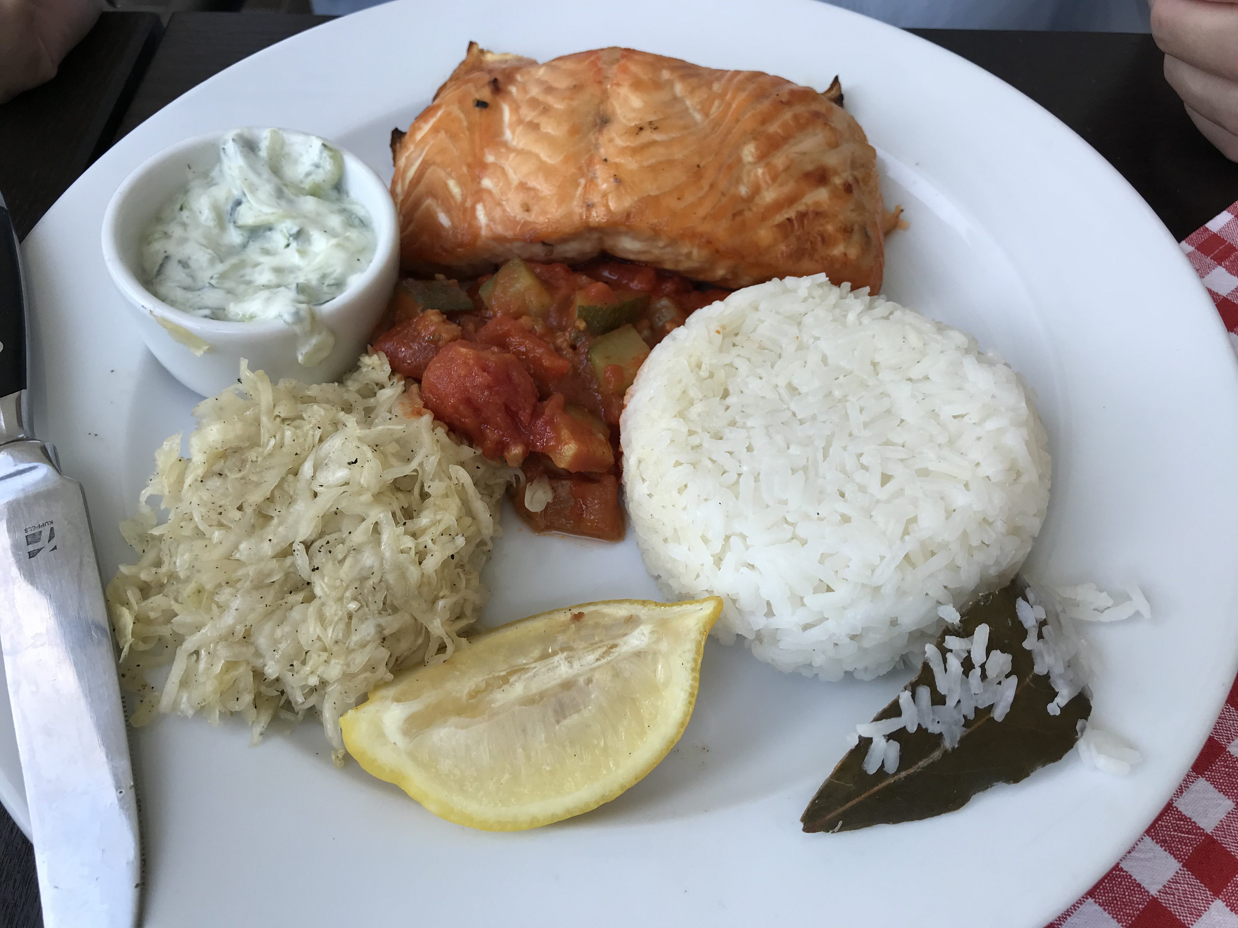 a plate of food with a lemon and rice