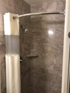 a shower with a white curtain