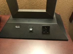 a black rectangular object with a rectangular frame and a rectangular outlet