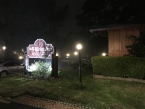 a sign in front of a building at night