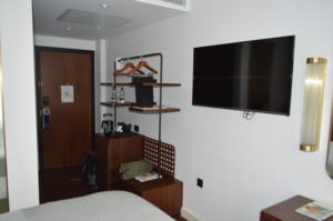 a room with a tv and a shelf