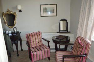 a room with striped chairs and a table