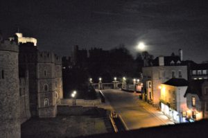 a city at night with a castle