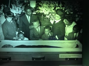 a group of people standing in a coffin