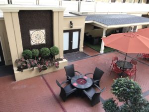 a patio with chairs and a table