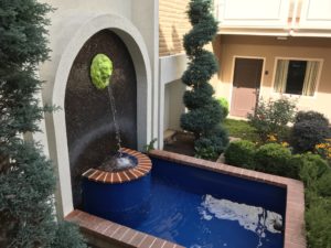 a small pool with a water fountain