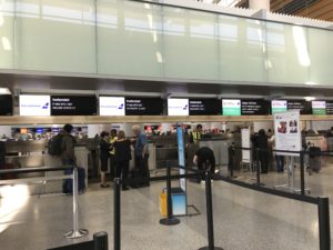 people standing in a line at an airport