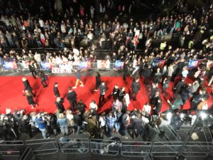 a crowd of people on a red carpet