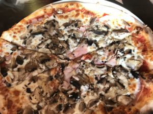 a pizza with mushrooms and cheese
