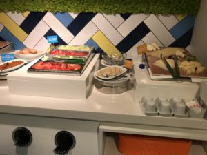 food on a counter with a colorful wall behind it