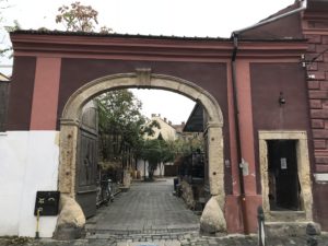 a stone archway over a brick road