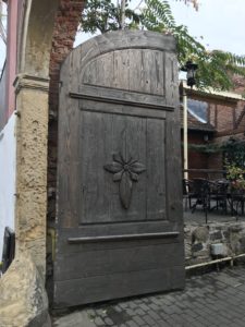 a wooden door with a flower carved on it