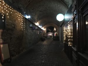 a brick tunnel with lights