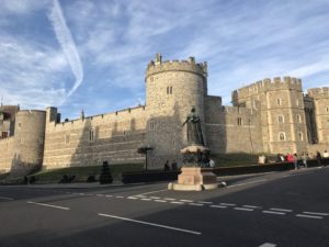 a stone castle with a statue in front of it