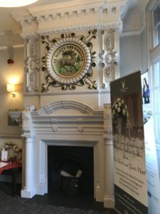 a fireplace with a picture on the wall