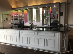 a bar with a mirror above it