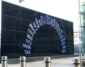 a black wall with blue letters