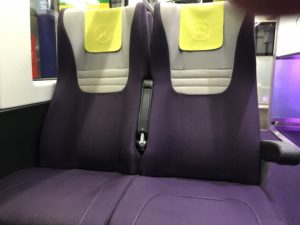 a purple and white seats on a bus