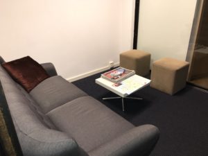 a couch and two brown cubes in a room