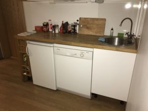 a white dishwasher and sink in a kitchen