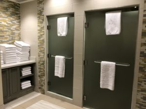 a bathroom with towels on doors