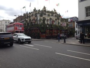 a street with cars and a double decker bus