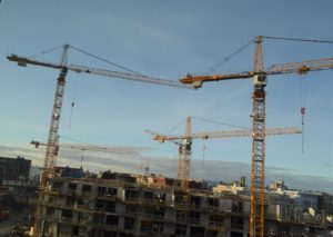 a group of cranes in a construction site