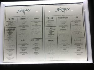 a menu on a glass case