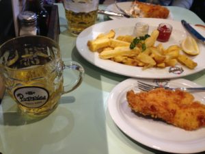 a plate of food and a glass of beer